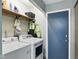 Practical laundry room with washer, dryer, and storage shelves at 8929 Sunburst Cir, Indianapolis, IN 46227