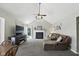 Comfortable living room featuring high ceilings, a fireplace, and a plush sectional sofa at 8929 Sunburst Cir, Indianapolis, IN 46227