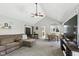 Open-concept living room with a vaulted ceiling, comfortable sofa, and seamless flow into the dining area at 8929 Sunburst Cir, Indianapolis, IN 46227