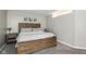 Cozy bedroom with a beautiful, rustic wooden bed and minimalist decor at 8929 Sunburst Cir, Indianapolis, IN 46227