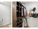 Walk-in closet with built-in dark wood shelving and hanging racks at 8929 Sunburst Cir, Indianapolis, IN 46227