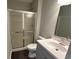 The bathroom features a glass door shower, light gray walls and new vanity and sink at 952 Delray Dr, Indianapolis, IN 46241