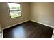 Cozy bedroom featuring dark wood floors and a bright window view at 952 Delray Dr, Indianapolis, IN 46241