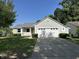 Charming home featuring a two-car garage, lush lawn, and inviting front porch on a sunny day at 952 Delray Dr, Indianapolis, IN 46241