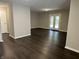 Spacious living room with hardwood floors, neutral paint and a door to the backyard at 952 Delray Dr, Indianapolis, IN 46241