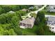 Aerial view of estate with lush landscaping, well-manicured lawns and brick home with deck at 1008 Westcreek Dr, Columbus, IN 47201