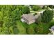 Lush aerial view of home featuring mature landscaping, sprawling lawn, and private deck space at 1008 Westcreek Dr, Columbus, IN 47201