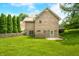 A well-kept brick house with a manicured lawn, tall trees, and a private back entrance at 1008 Westcreek Dr, Columbus, IN 47201
