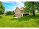 Brick house with a well-maintained lawn and mature trees, offering a serene outdoor space at 1008 Westcreek Dr, Columbus, IN 47201