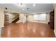 Finished basement space with laminate flooring, home theater area, and staircase at 1008 Westcreek Dr, Columbus, IN 47201