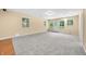 Finished basement with a carpeted area, a door leading outside, and several windows at 1008 Westcreek Dr, Columbus, IN 47201