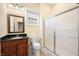 Bathroom featuring granite countertops, wood cabinets, and a glass-enclosed shower at 1008 Westcreek Dr, Columbus, IN 47201