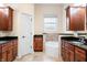 Bathroom with granite countertops, wood cabinets, walk-in shower, and soaking tub at 1008 Westcreek Dr, Columbus, IN 47201