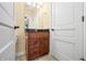 Bathroom with dark wood cabinet, granite countertop, and mirror at 1008 Westcreek Dr, Columbus, IN 47201