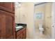 Bathroom featuring a vanity with granite countertop and a view into the toilet and shower area at 1008 Westcreek Dr, Columbus, IN 47201
