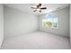 Light and airy bedroom with neutral carpet, ceiling fan, and a window for ample natural light at 1008 Westcreek Dr, Columbus, IN 47201