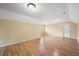 Large room features hardwood floors, light tan walls, bright lighting, and attic-style ceiling at 1008 Westcreek Dr, Columbus, IN 47201