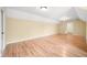 Large room features light hardwood floors, light tan walls, bright lighting, and attic-style ceiling at 1008 Westcreek Dr, Columbus, IN 47201