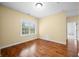 Bright bedroom features hardwood floors, light tan walls, and large window allowing for plenty of natural light at 1008 Westcreek Dr, Columbus, IN 47201