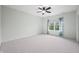 Bright bedroom with ceiling fan, neutral carpet, and window with decorative blue curtains at 1008 Westcreek Dr, Columbus, IN 47201