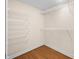Walk-in closet with metal shelving and wood floors at 1008 Westcreek Dr, Columbus, IN 47201
