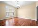 Spacious dining room with hardwood floors, chandelier, and large window at 1008 Westcreek Dr, Columbus, IN 47201