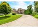 Lovely brick home with a long driveway and well-manicured lawn, exuding curb appeal and charm at 1008 Westcreek Dr, Columbus, IN 47201