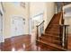 Grand foyer with hardwood floors, staircase, high ceilings, and an arched doorway, offering a luxurious feel at 1008 Westcreek Dr, Columbus, IN 47201