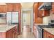 Close-up showcasing stainless steel appliances, granite countertops, and rich wood cabinetry in this kitchen at 1008 Westcreek Dr, Columbus, IN 47201