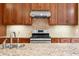 Close up of the kitchen with granite countertops, tile backsplash, and stainless steel gas range at 1008 Westcreek Dr, Columbus, IN 47201