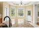 Bright kitchen with granite countertops, stainless steel faucet, and door to the backyard at 1008 Westcreek Dr, Columbus, IN 47201