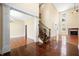 Open-concept living area with hardwood floors, staircase, and ample natural light creating a spacious atmosphere at 1008 Westcreek Dr, Columbus, IN 47201
