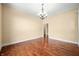 Bright living room featuring hardwood floors, chandelier, and neutral walls at 1008 Westcreek Dr, Columbus, IN 47201