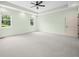 Large main bedroom with carpet, ceiling fan, and natural light from two windows at 1008 Westcreek Dr, Columbus, IN 47201