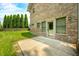 Brick house with a well-maintained lawn and mature trees, featuring a patio area and yard at 1008 Westcreek Dr, Columbus, IN 47201