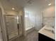 Elegant bathroom featuring a double sink vanity, walk-in shower with glass door, and soaking tub at 10144 Camp Creek Way, Indianapolis, IN 46229