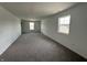 Spacious bonus room featuring plush carpeting, neutral walls, and bright natural light from well-placed windows at 10144 Camp Creek Way, Indianapolis, IN 46229