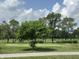 Scenic view of the community golf course with mature trees and a peaceful setting on a bright day at 10144 Camp Creek Way, Indianapolis, IN 46229