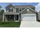 Charming two-story home features a brick and siding exterior, attached two-car garage, and well-manicured front lawn at 10144 Camp Creek Way, Indianapolis, IN 46229