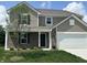 Charming two-story home featuring a well-manicured lawn and attached garage at 10144 Camp Creek Way, Indianapolis, IN 46229