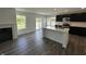 Modern kitchen featuring dark cabinetry, stainless steel appliances, white countertop island and luxury vinyl floors at 10144 Camp Creek Way, Indianapolis, IN 46229