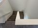 A modern staircase with carpeted steps and white handrails leads to the next floor at 10144 Camp Creek Way, Indianapolis, IN 46229