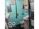 Functional basement bathroom with basic fixtures, teal walls, and necessary plumbing exposed at 10210 E 33Rd St, Indianapolis, IN 46235