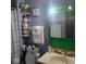 Bathroom featuring green vanity, decorative shelves, and a stylish shower curtain for a neat aesthetic at 10210 E 33Rd St, Indianapolis, IN 46235