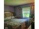 Bright bedroom with a well-dressed bed, window with natural light, and floral curtains for added charm at 10210 E 33Rd St, Indianapolis, IN 46235