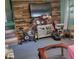 Eclectic living room featuring wood accent wall and casual arrangement of furniture and home exercise equipment at 10210 E 33Rd St, Indianapolis, IN 46235