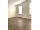Bright bedroom featuring hard wood floors, neutral paint, and two windows bringing in natural light at 10477 Silver Ridge Cir, Fishers, IN 46038