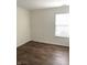 Bright bedroom featuring hard wood floors, neutral paint, and a window bringing in natural light at 10477 Silver Ridge Cir, Fishers, IN 46038