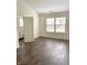 Bright bedroom featuring hard wood floors, neutral paint, two windows and an en suite bathroom at 10477 Silver Ridge Cir, Fishers, IN 46038