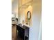 Close up of decorative niche featuring an oval mirror, modern lantern, and rustic shelving at 10477 Silver Ridge Cir, Fishers, IN 46038